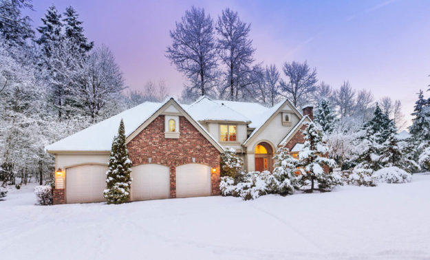 Driveway view of snowy home – daylight fades over a snow-covered