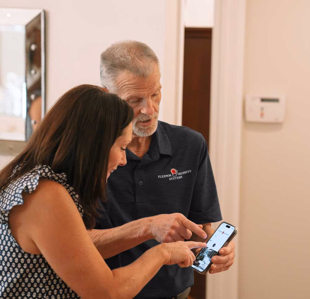 Technician showing client how to use the Fleenor mobile app.