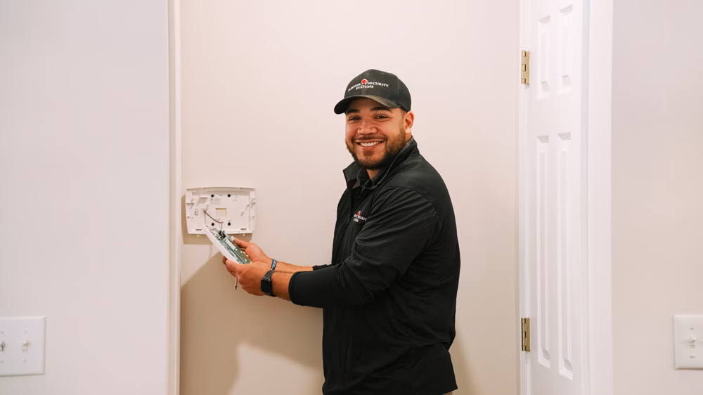 Fleenor technician installing a wall mount security panel.
