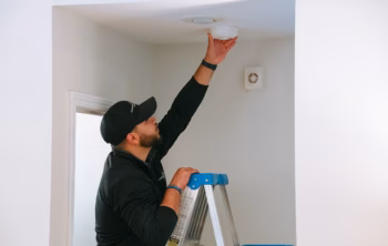 fleenor staff fixing a light bulb
